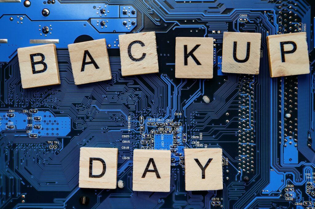 Words in English Backup day. Copy space for text. HDD hard drive. hard disk on black dark background. WordPress backup best practices.